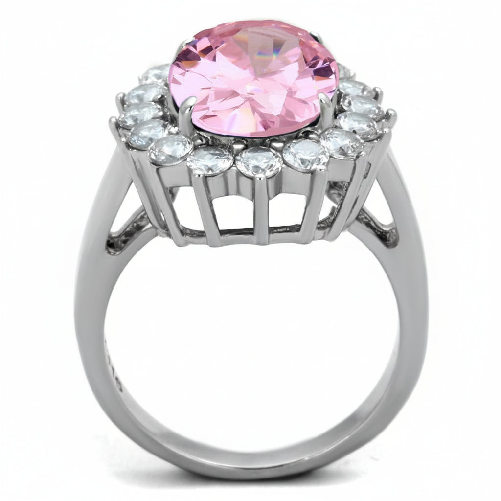 Ring with a pink gemstone and clear stones on a white background