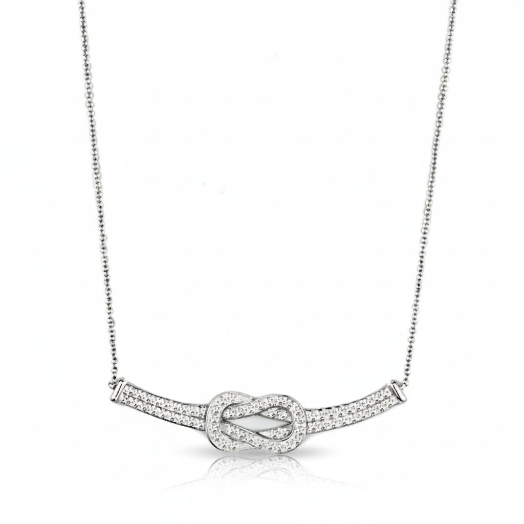 Silver necklace with a knot design on a white background