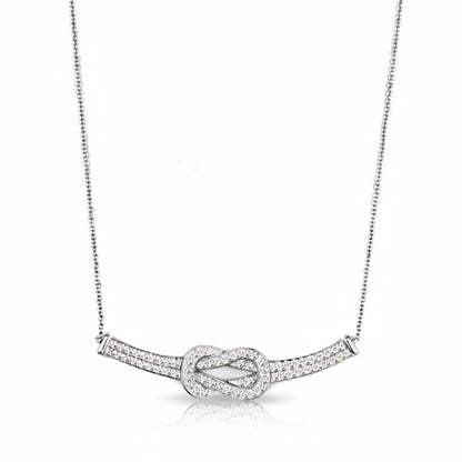Silver necklace with a knot design on a white background