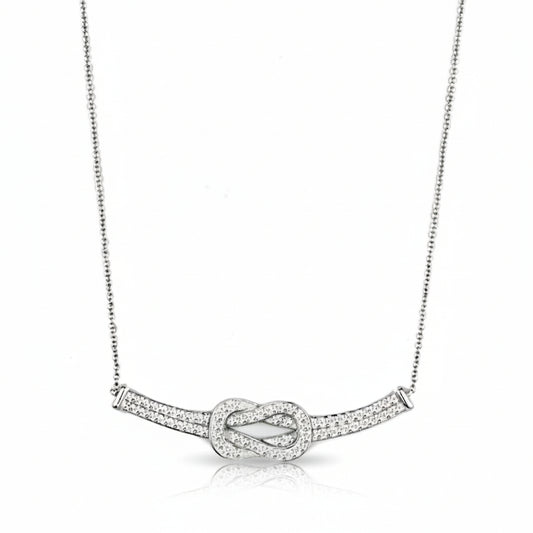 Silver necklace with a knot design on a white background