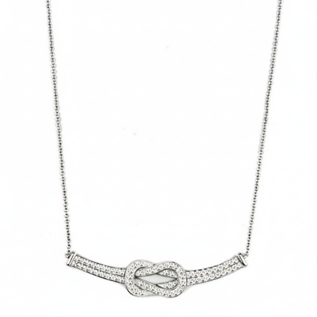 Silver necklace with a knot design on a white background