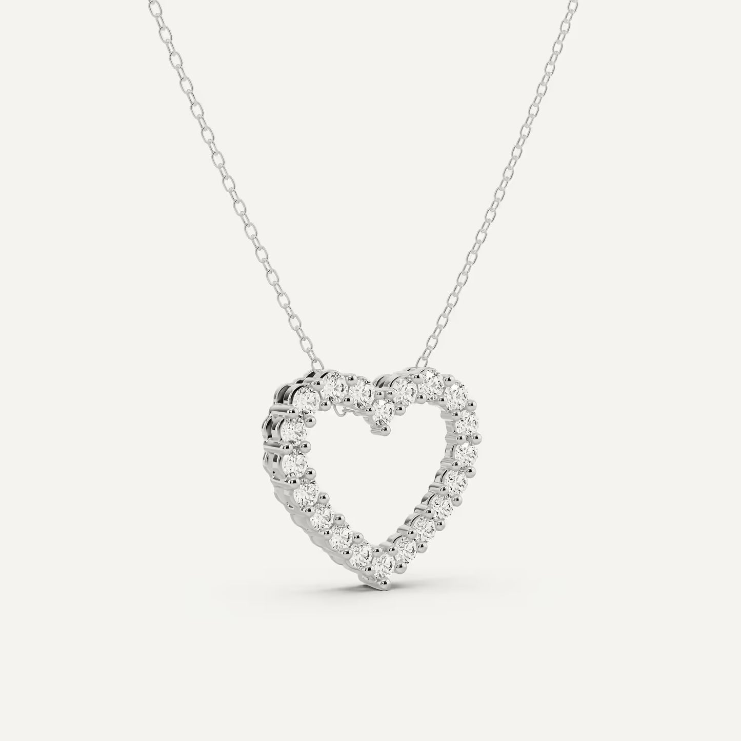 Heart-shaped diamond necklace on a light gray background