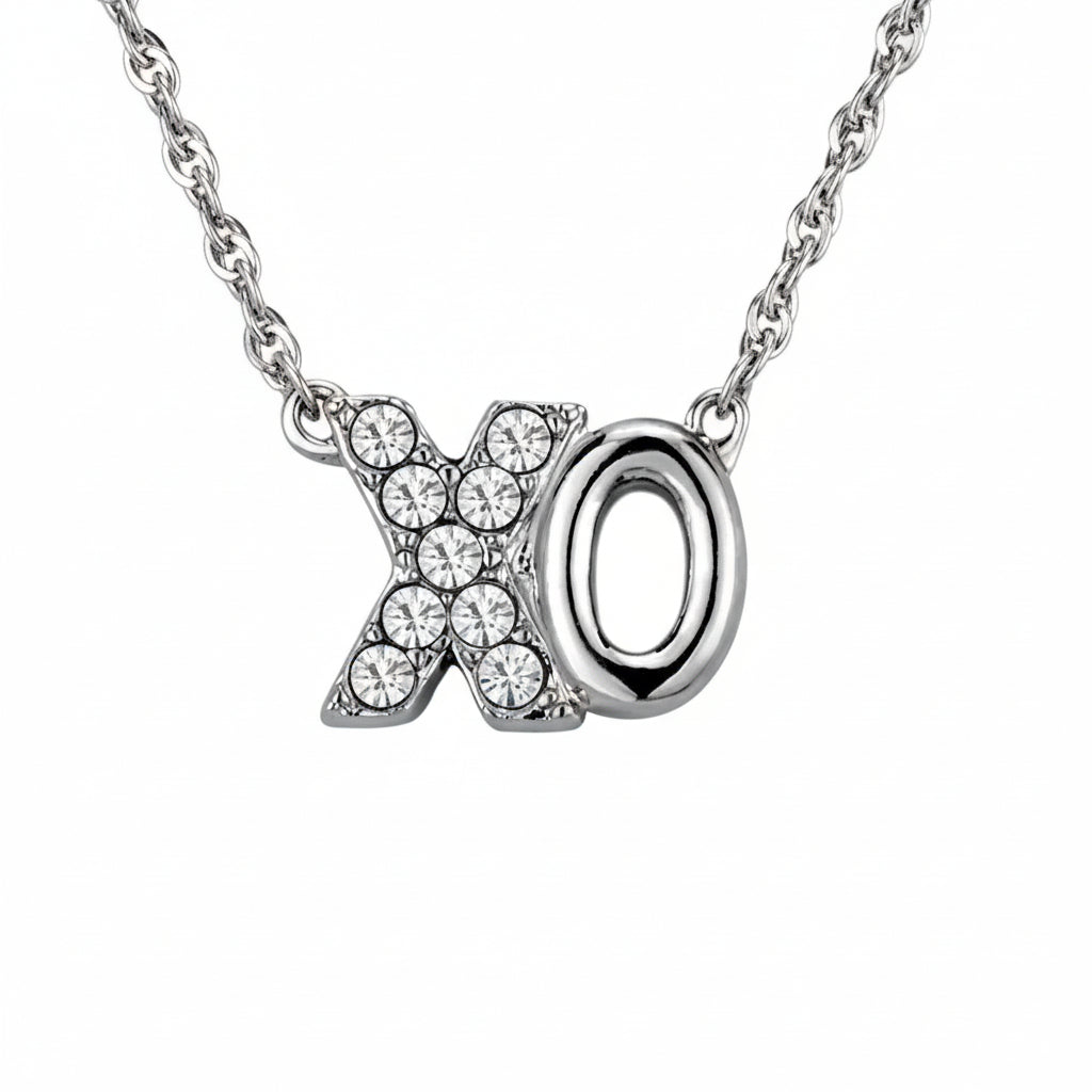 Silver necklace with 'xo' pendant and measurements on a white background