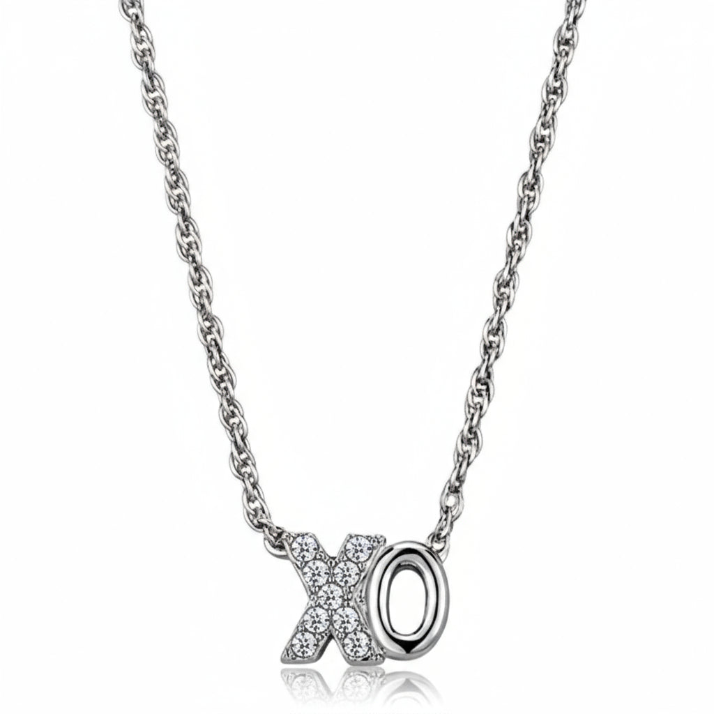 Silver necklace with 'X' and 'O' pendant on a white background