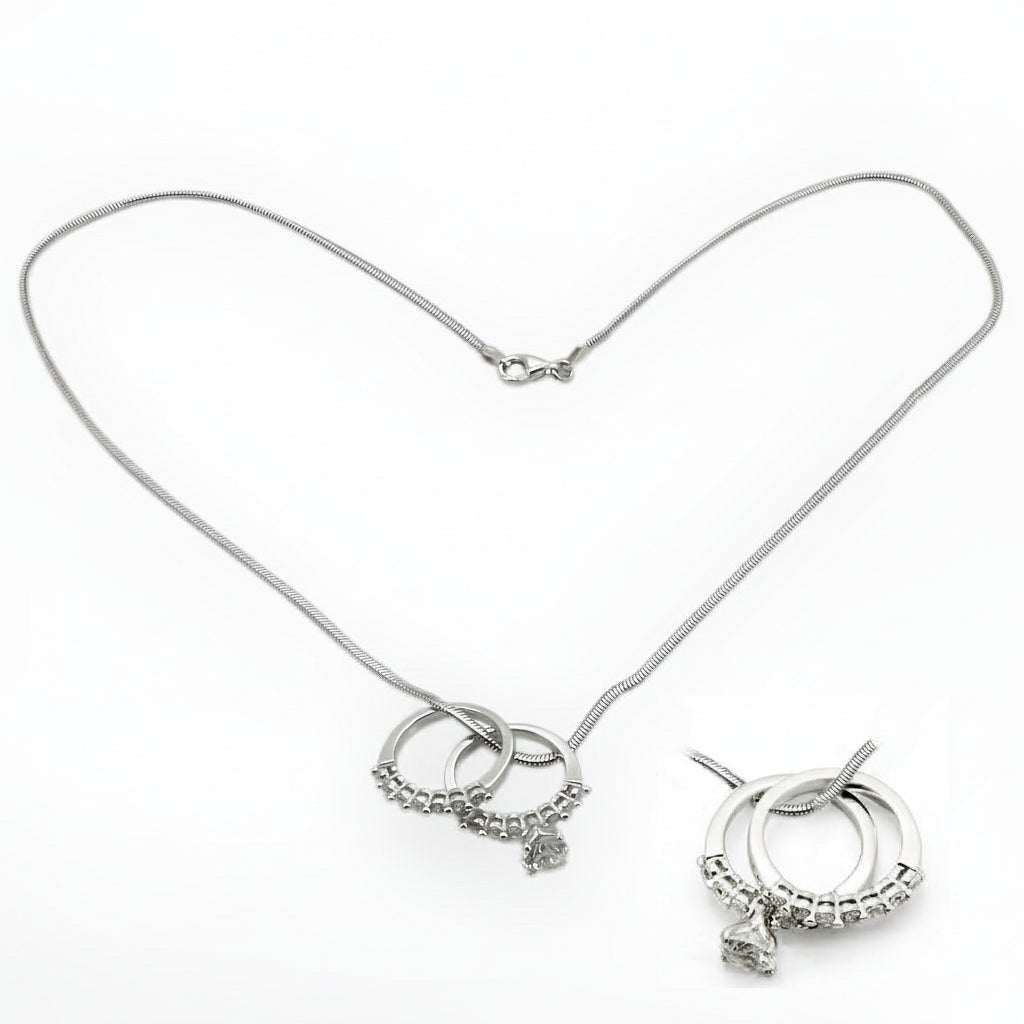 Silver necklace with circular charms on a white background