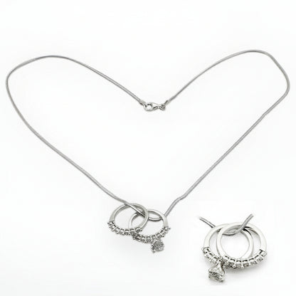 Silver necklace with circular charms on a white background