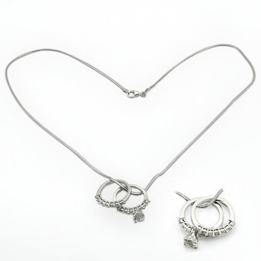 Silver necklace with circular charms on a white background