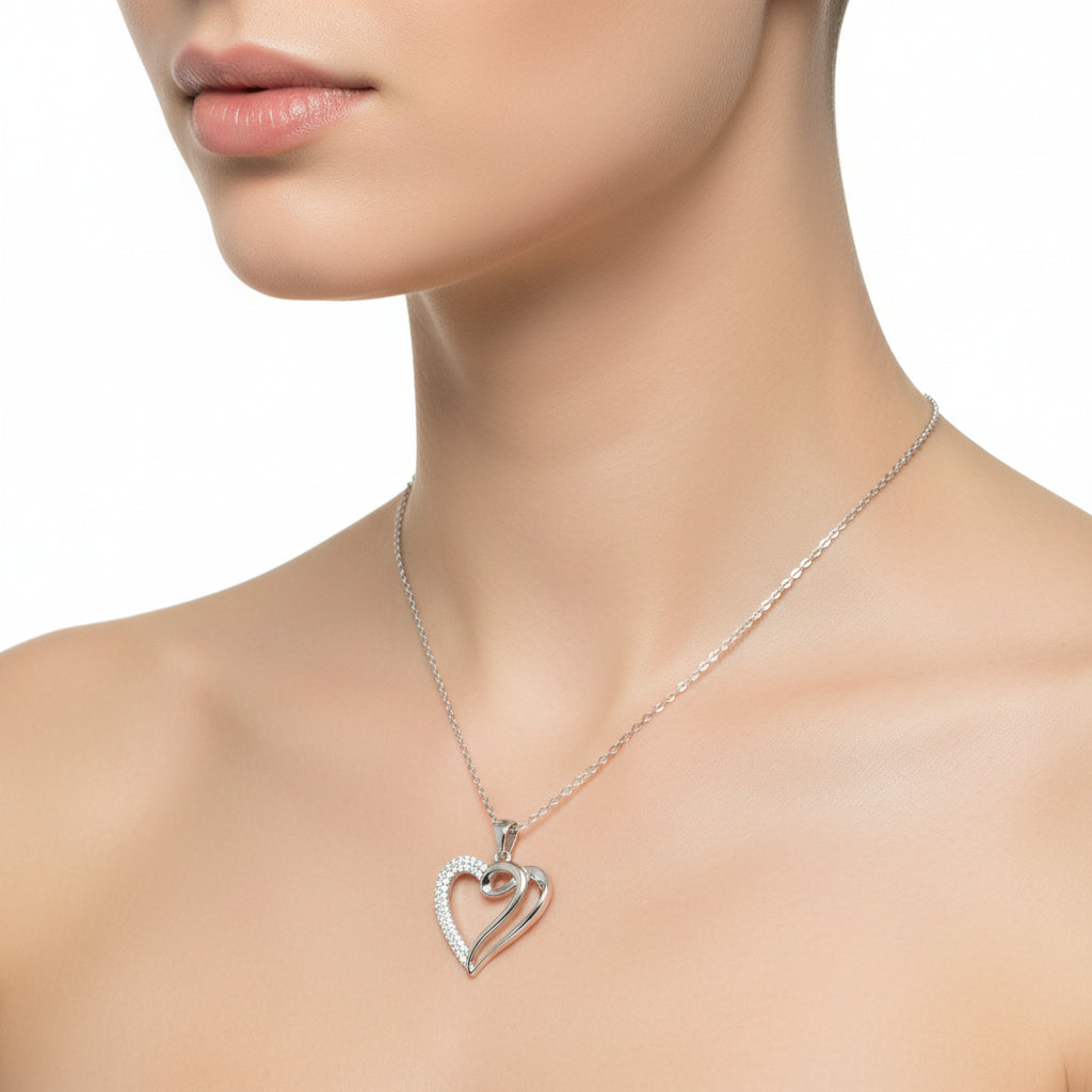 Silver heart-shaped necklace with a chain on a white background